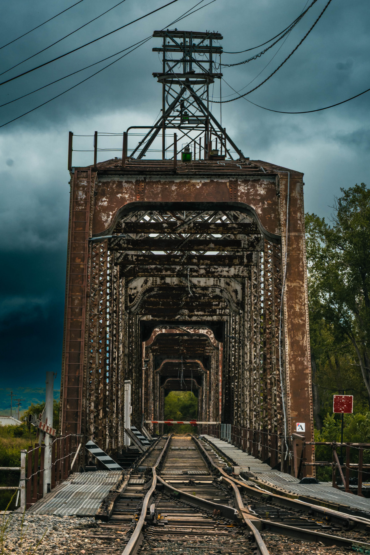 The Atchison Railroad Bridge — a rusted steel railroad bridge under a stormy sky