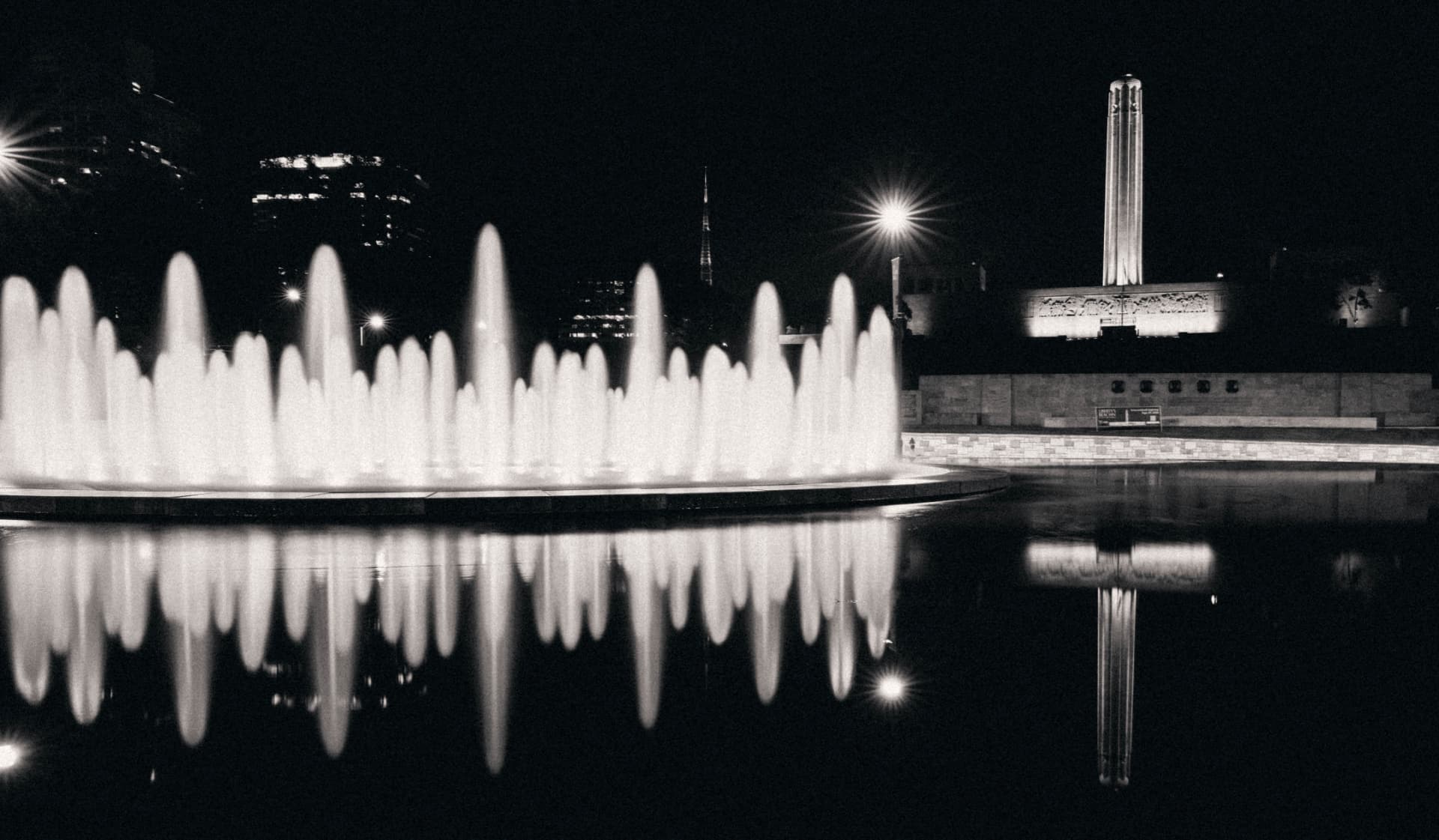 100 Years — the Liberty Memorial reflected in still water, black and white